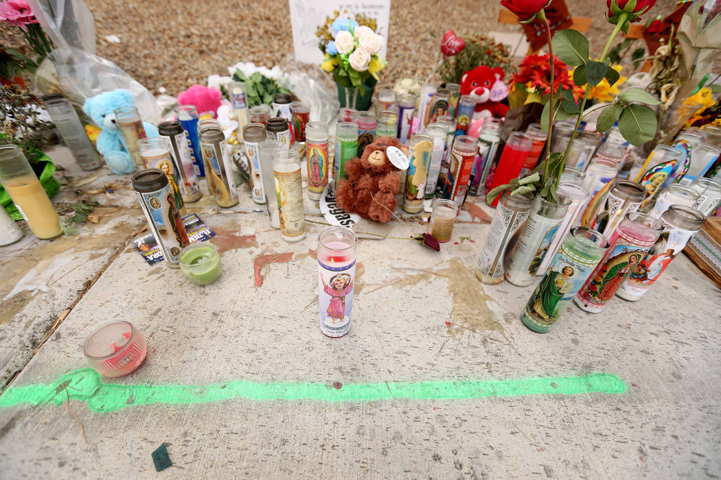 Cars pass a memorial site Oct. 18, 2017 where three juveniles between the ages of 12 and 15 were hit by a car on Desert Inn Road and east of Nellis Boulevard in Las Vegas. Elizabeth Brumley Las Ve ...