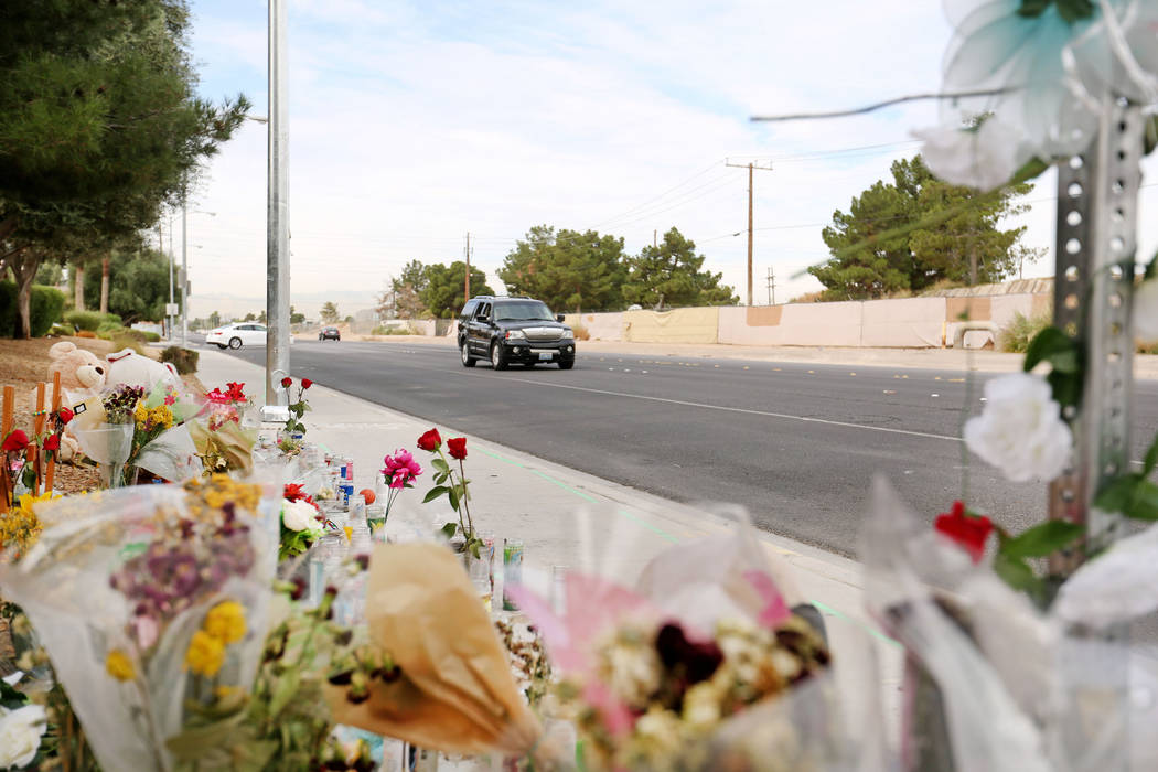 A car passes a memorial site on Wednesday, Oct. 18, 2017 where three juveniles between the ages of 12 and 15 were hit by a car on Desert Inn Road and east of Nellis Boulevard in Las Vegas. Elizabe ...