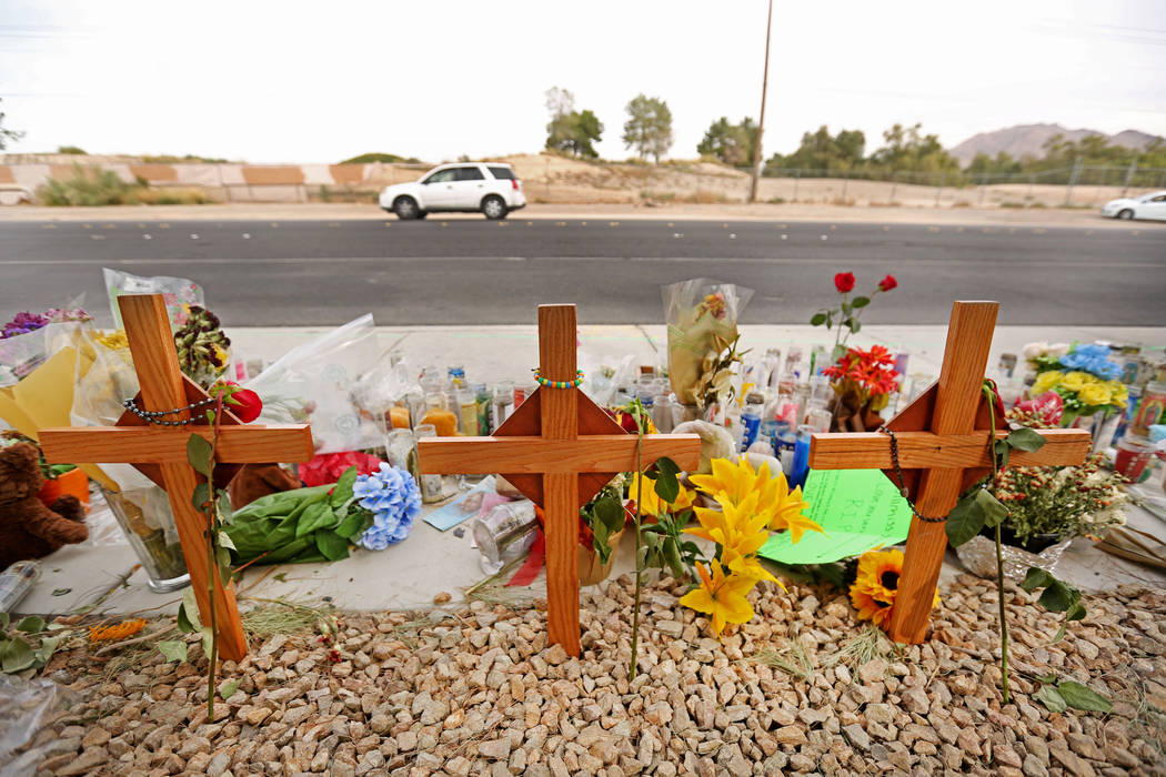 A car passes a memorial site on Wednesday, Oct. 18, 2017 where three juveniles between the ages of 12 and 15 were hit by a car on Desert Inn Road and east of Nellis Boulevard in Las Vegas. Elizabe ...