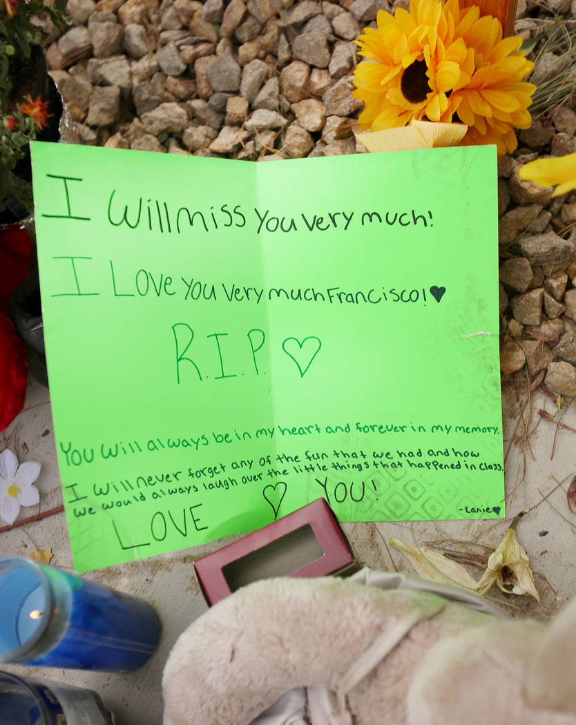 A note is left at a memorial site on Wednesday, Oct. 18, 2017 where three juveniles between the ages of 12 and 15 were hit by a car on Desert Inn Road and east of Nellis Boulevard in Las Vegas. El ...