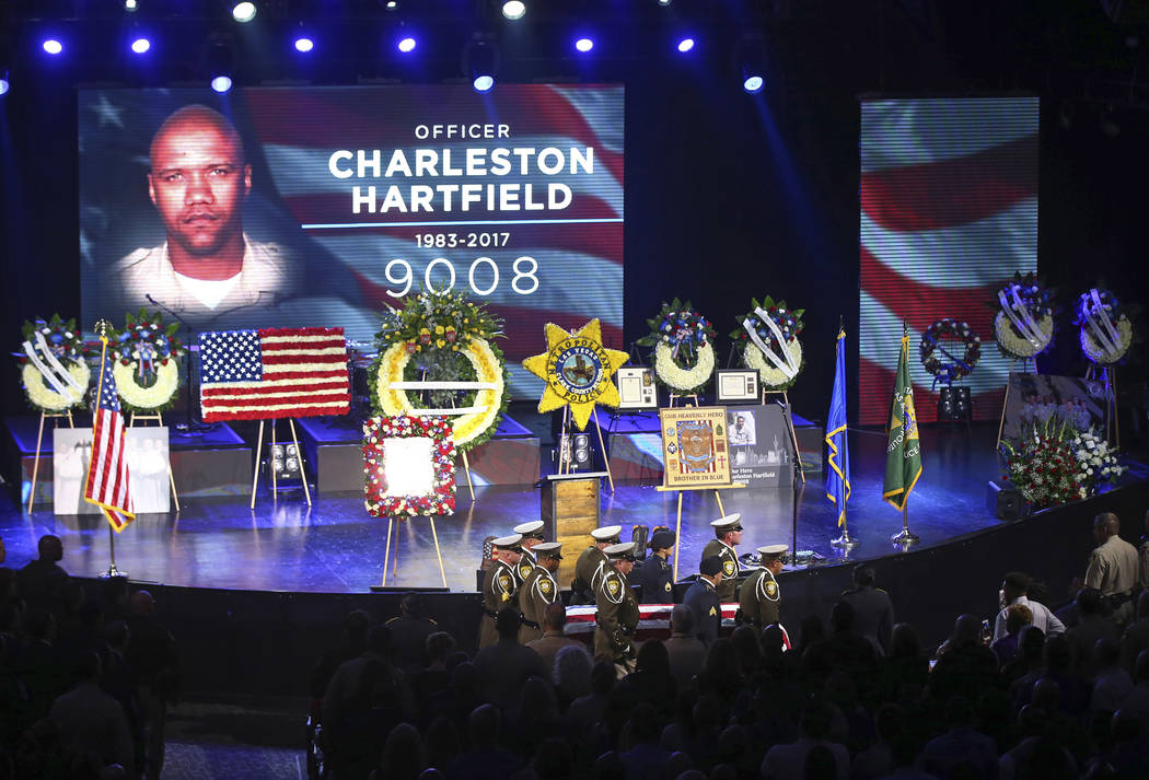 Pallbearers guide in the casket of Las Vegas police officer Charleston Hartfield during his funeral, Friday, Oct. 20, 2017, in Henderson, Nev. Hartfield was killed by a gunman shooting from a hote ...