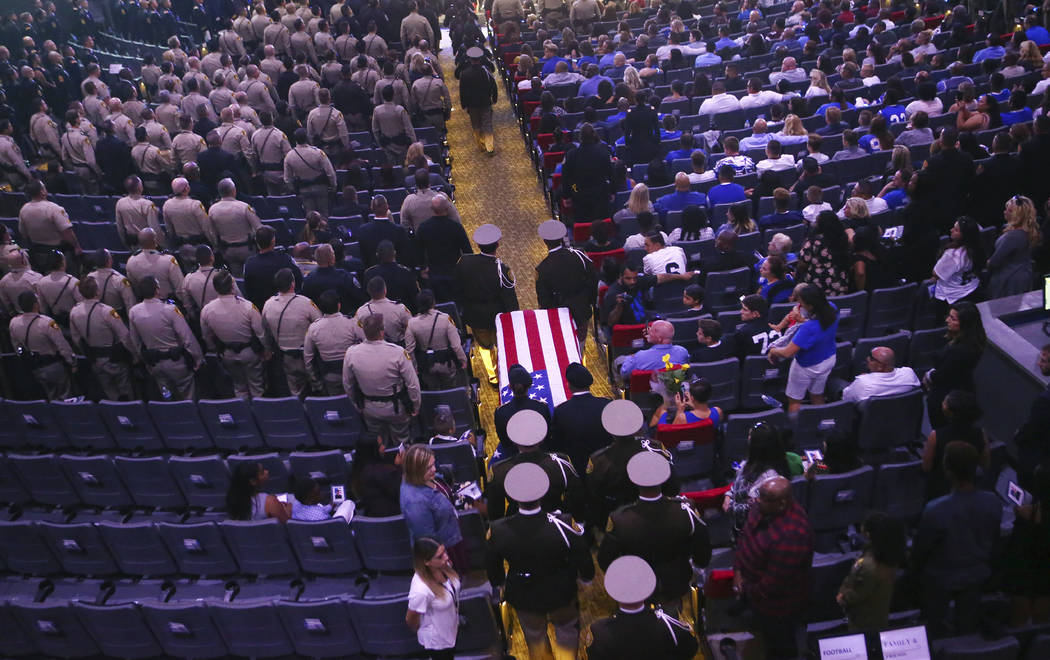 Pallbearers guide in the casket of Las Vegas police officer Charleston Hartfield during his funeral, Friday, Oct. 20, 2017, in Henderson, Nev. Hartfield was killed by a gunman shooting from a hote ...