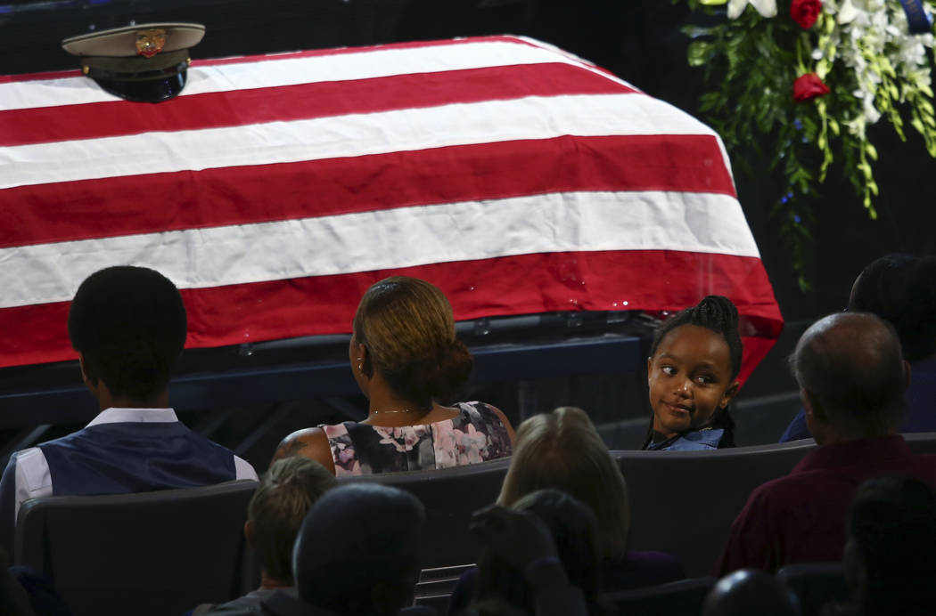 Savannah Hartfield, right, looks back at the audience during a funeral for her father Las Vegas police officer Charleston Hartfield, Friday, Oct. 20, 2017, in Henderson, Nev. Hartfield was killed  ...
