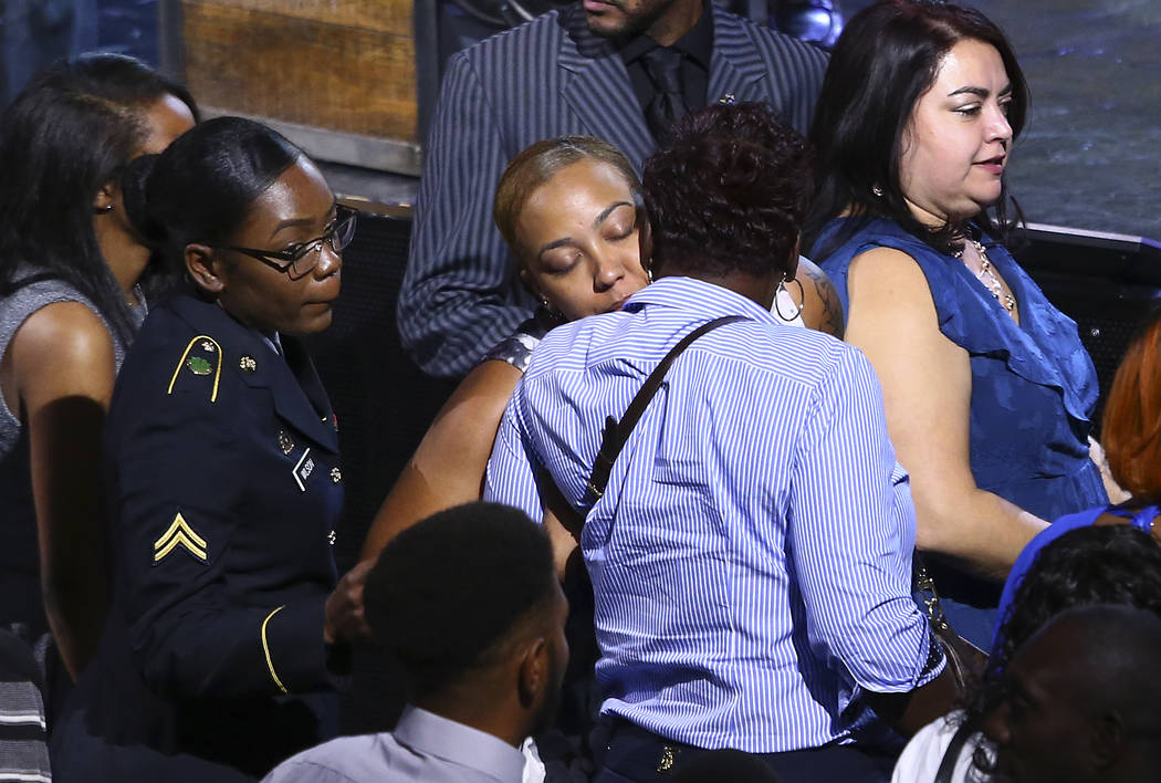 Veronica Hartfield, center, is hugged during a funeral for her husband Las Vegas police officer Charleston Hartfield, Friday, Oct. 20, 2017, in Henderson, Nev. Hartfield was killed by a gunman sho ...