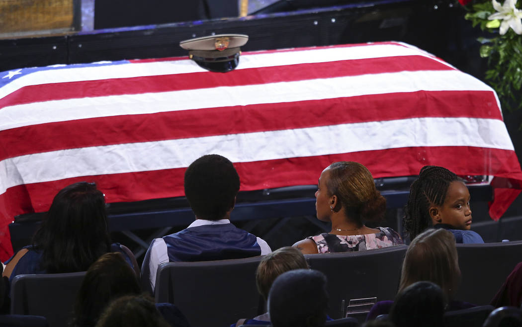 Family members including daughter Savannah Hartfield, right, listen during a funeral for Las Vegas police officer Charleston Hartfield, Friday, Oct. 20, 2017, in Henderson, Nev. Hartfield was kill ...