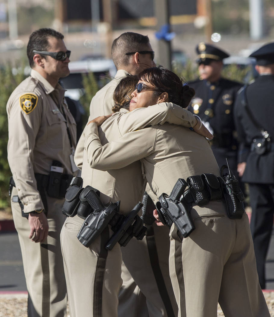 Metro officers comfort each other outside Central Church before the start of the service for Charleston Hartfield, the off-duty officer killed during the Route 91 shooting on Friday, October, 20,  ...