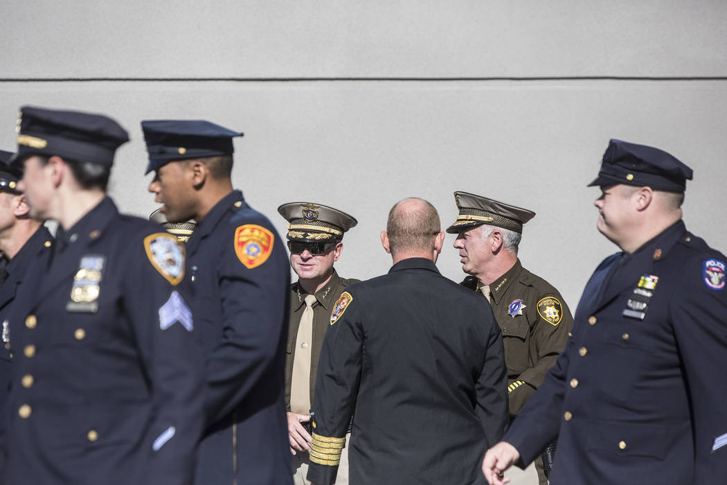 Sheriff Joe Lombardo, second from right, waits outside of Central Church with fellow Metro officers for the funeral procession to arrive before the start of the service for Charleston Hartfield, ...