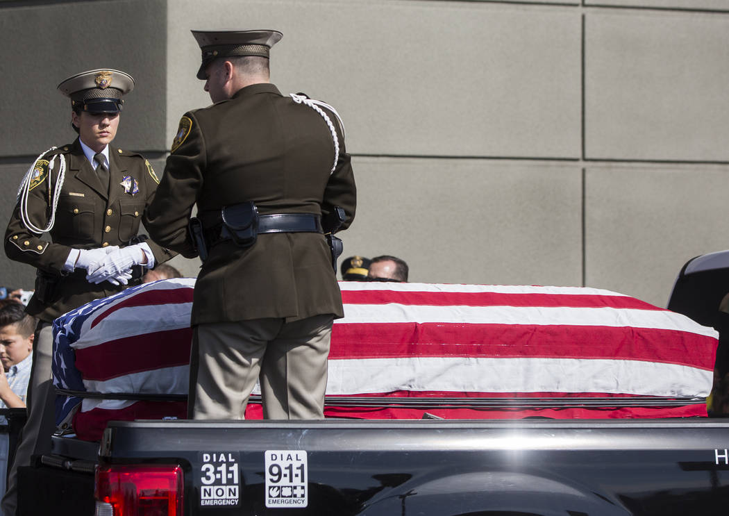 Metro officers prepare to carry the body of Charleston Hartfield into Central Church during a service for the off-duty officer killed during the Route 91 shooting on Friday, October, 20, 2017, in ...