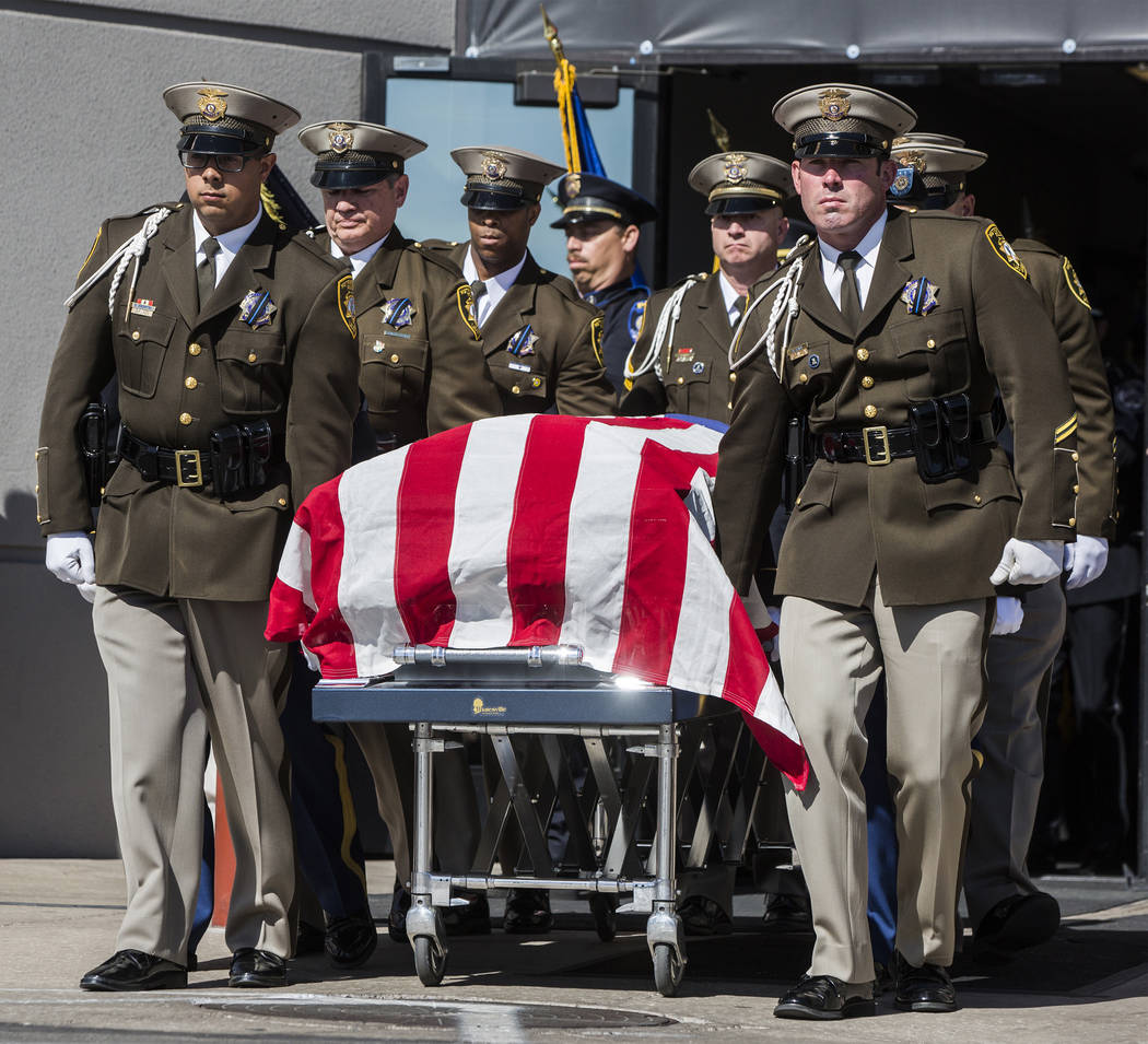 The body of Charleston Hartfield is carried out of Central Church by fellow Metro officers at the conclusion of the service for the off-duty officer killed during the Route 91 shooting on Friday, ...