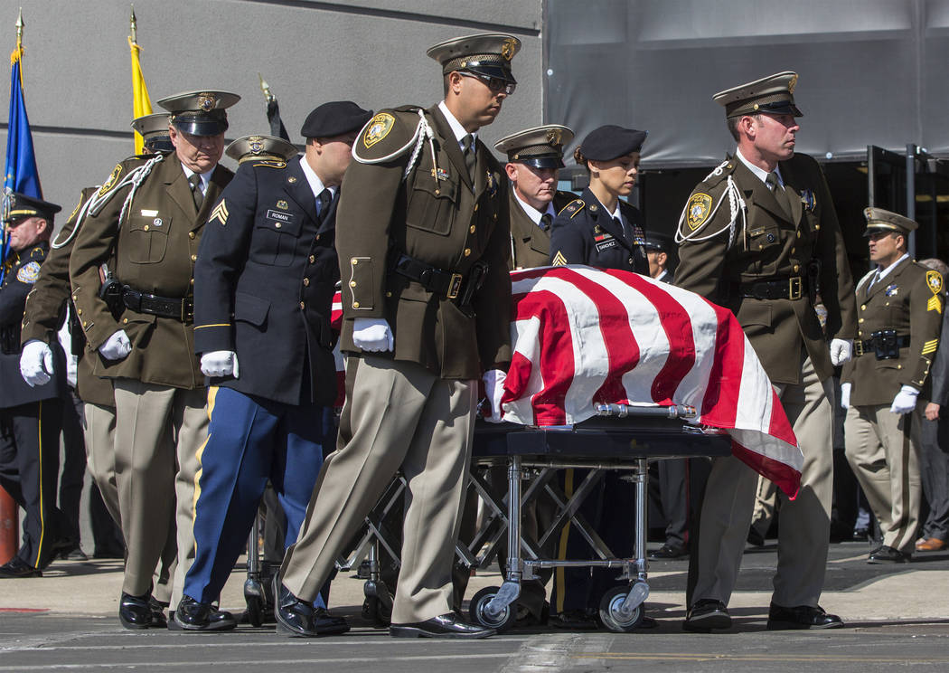The body of Charleston Hartfield is carried out of Central Church by fellow Metro officers at the conclusion of the service for the off-duty officer killed during the Route 91 shooting on Friday, ...