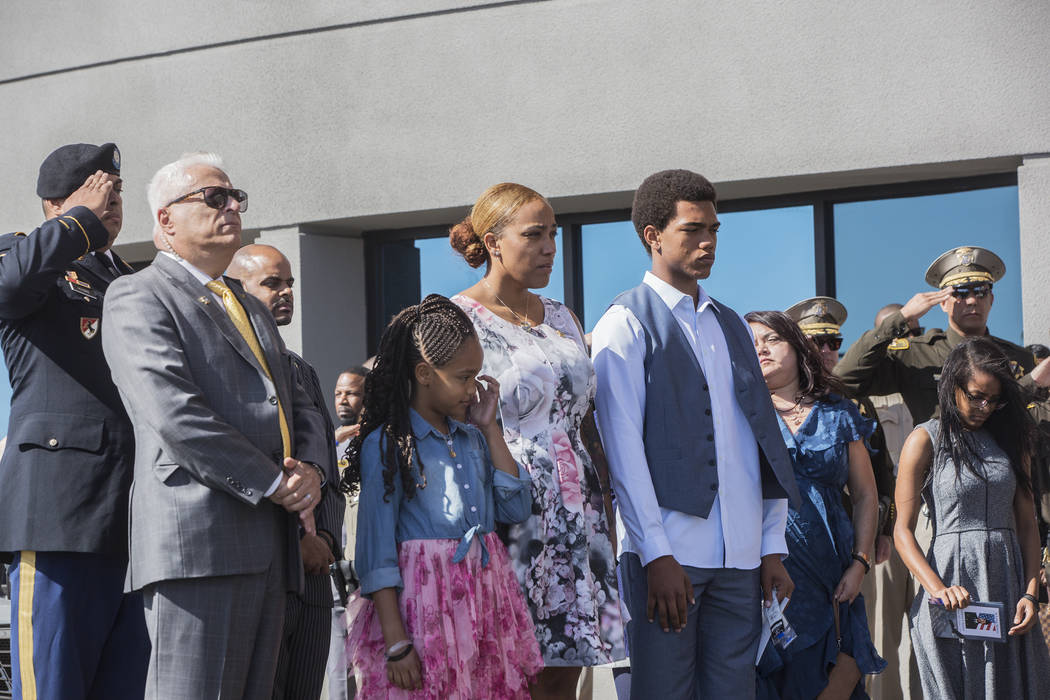 Charleston Hartfield's daughter Savannah, third from left, widow Veronica and son Ayzayah watch the fallen officer's body be taken out of Central Church at the conclusion of the Route 91 shooting ...