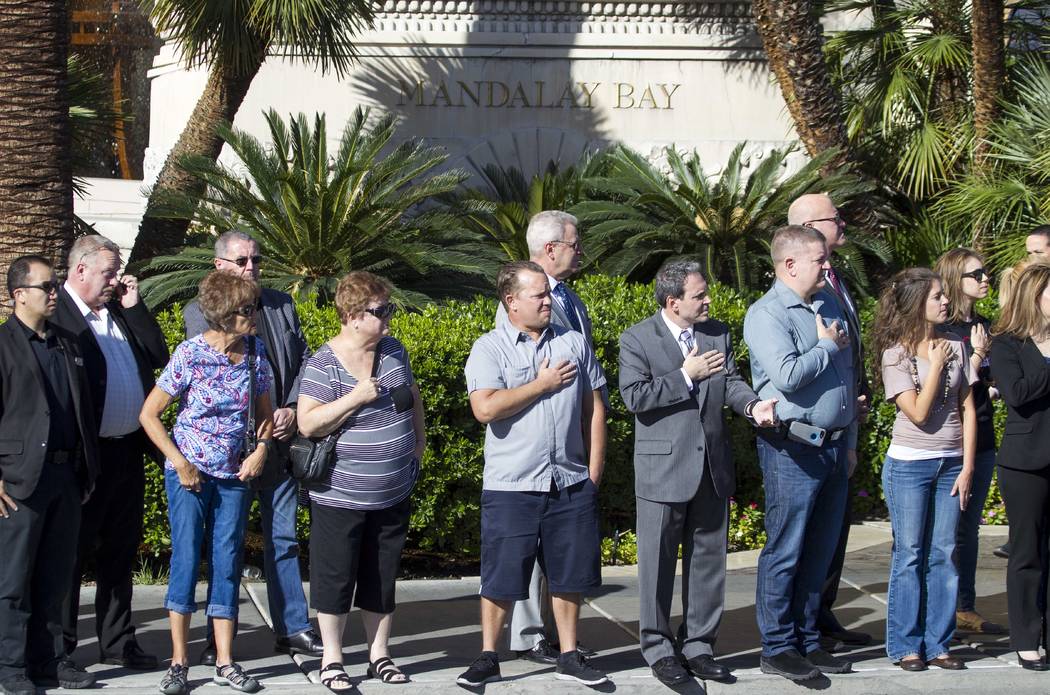 Mandalay Bay employees and passersby pay their respects as the procession for Metro officer Charleston Hartfield drives by the Mandalay Bay en route to a memorial service on Friday, Oct. 20, 2017. ...