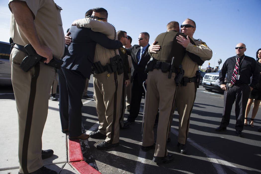 Las Vegas police officers embrace before the funeral service for Las Vegas Police Officer Charleston Hartfield at Central Christian Church in Henderson on Friday, Oct. 20, 2017. Hartfield was kill ...