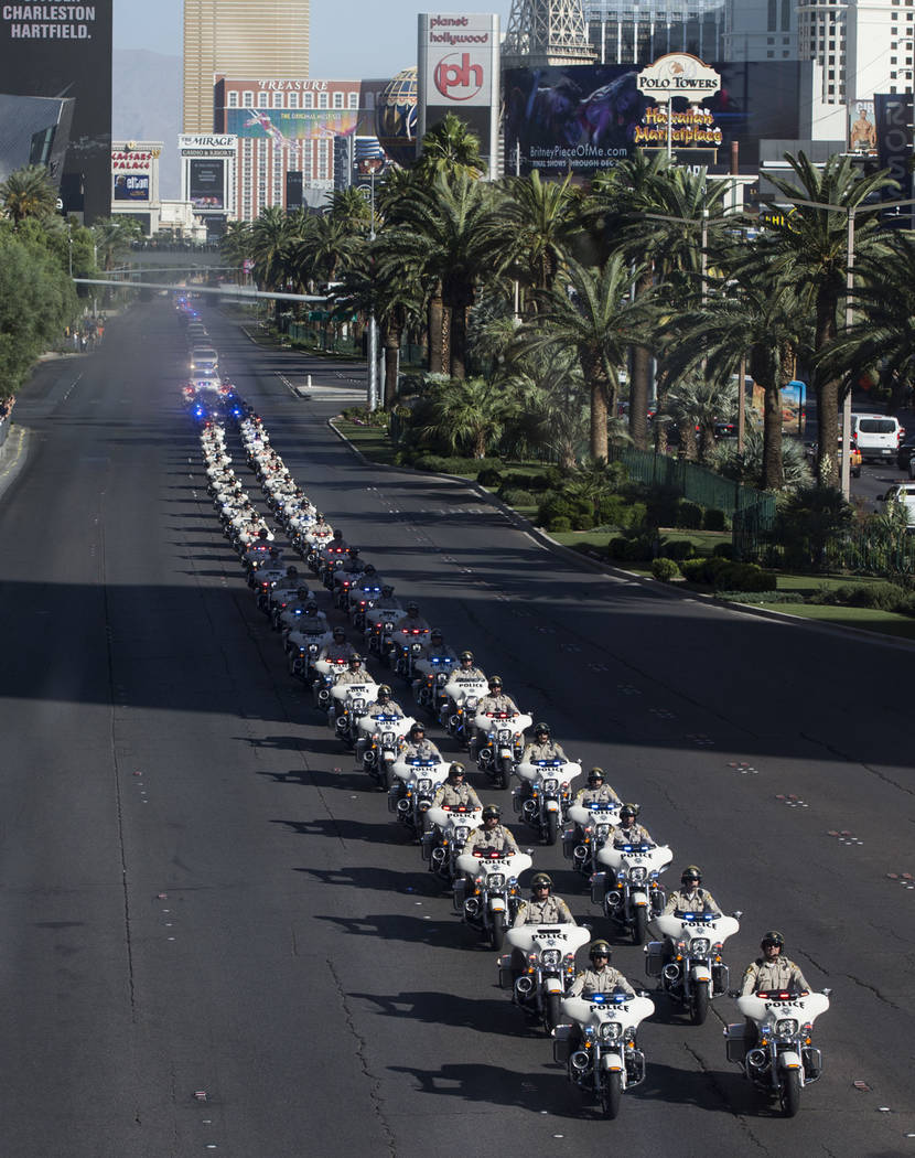 The funeral procession of Las Vegas police officer and Nevada National Guard veteran Charleston Hartfield, at the intersection of Tropicana Avenue and Las Vegas Boulevard in Las Vegas, Friday, Oct ...