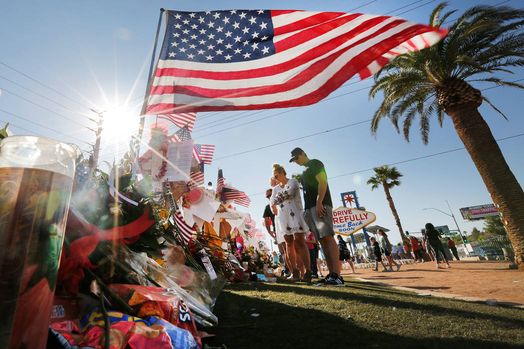 People gather at the Welcome to Fabulous Las Vegas sign in Las Vegas, Saturday, Oct. 14, 2017. A makeshift memorial for the mass shooting victims were placed near the sign.  Chitose Suzuki Las Veg ...