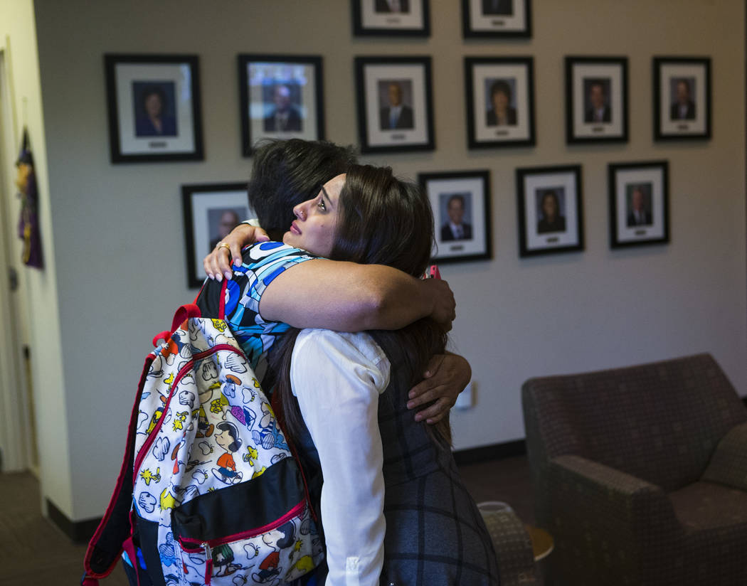 Simona Johnson, mother of a daughter with HIV, left, embraces Dina Patel, a nurse practitioner at the pediatric HIV program at UNLV's School of Community Health Sciences, after attending a meeting ...