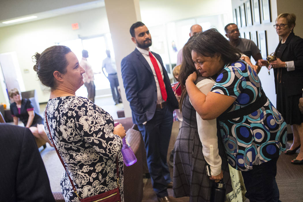 Simona Johnson, mother of a daughter with HIV, far right, embraces Dina Patel, a nurse practitioner at the pediatric HIV program at UNLV's School of Community Health Sciences, after attending a me ...
