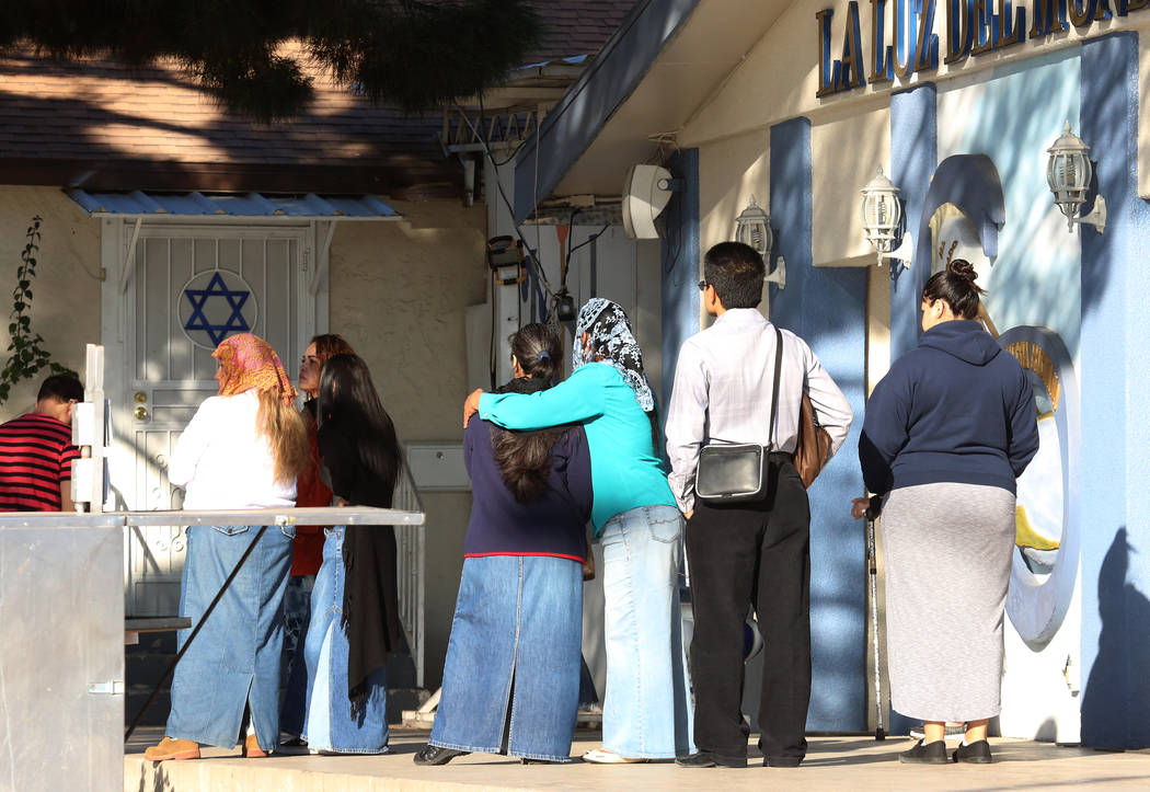 Churchgoers gather outside Iglesia La Luz del Mundo at Cedar Avenue where a man suffering gunshot wounds to his head and shoulder was found near Eastern Avenue Monday, Oct. 16, 2017, in Las Vegas. ...