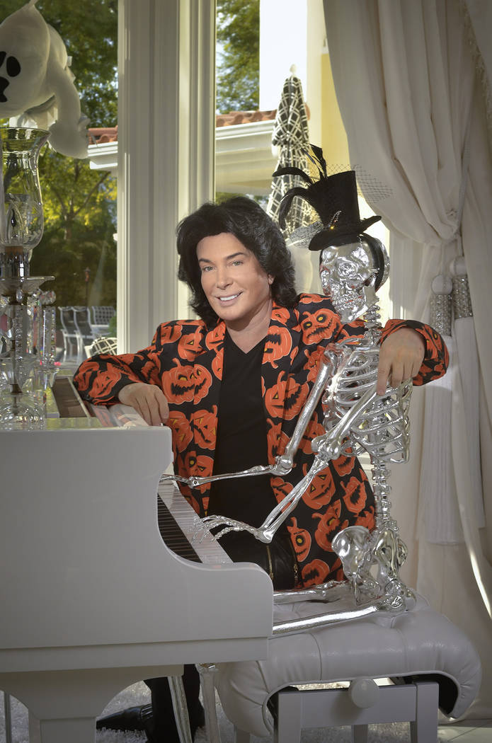 Las Vegas entertainer Frank Marino poses with the new addition to his Halloween collection, "Mr. Bone-Jangles," who is seated at the Steinway piano. (Bill Hughes Real Estate Millions)