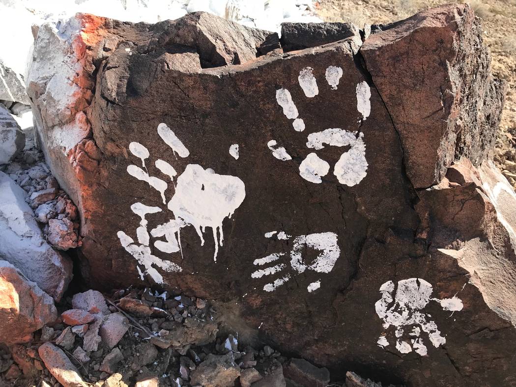 Messages and handprints are left on a rock just below a giant Q in honor of Quinton Robbins on Saturday, Oct. 21, 2017, on the mountain east of Basic High School in Henderson. Friends and family o ...