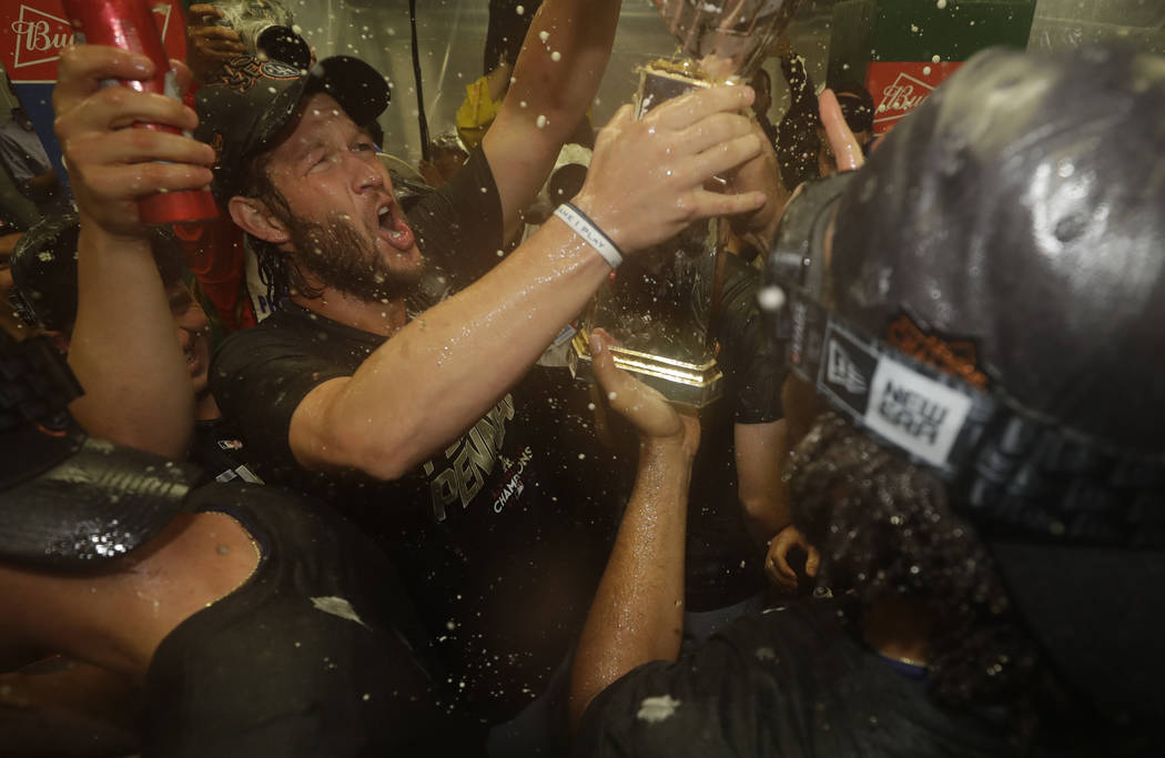 Los Angeles Dodgers' Clayton Kershaw, left, and his teammates celebrate after Game 5 of baseball's National League Championship Series against the Chicago Cubs, Thursday, Oct. 19, 2017, in Chicago ...