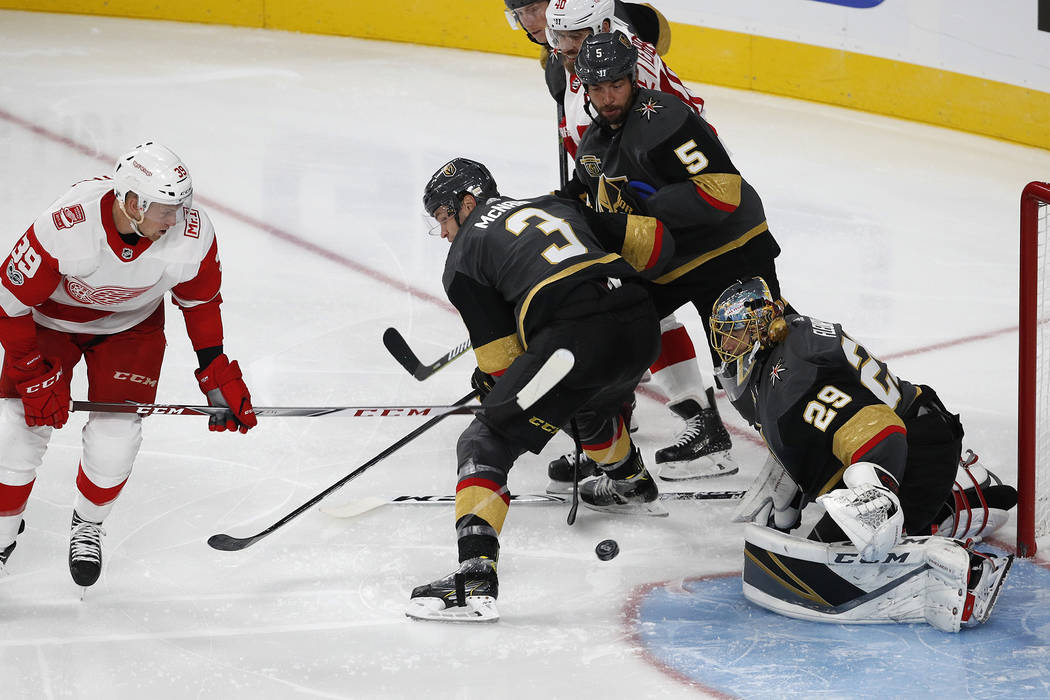Vegas Golden Knights goalie Marc-Andre Fleury blocks a shot by Detroit Red Wings right wing Anthony Mantha, left, during the third period of an NHL hockey game Friday, Oct. 13, 2017, in Las Vegas. ...