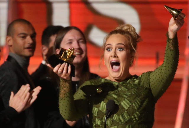 Adele breaks the Grammy for Record of the Year for "Hello" after having it presented to her at the 59th Annual Grammy Awards in Los Angeles, California, U.S., February 12, 2017. Lucy Nicholson/Reuters