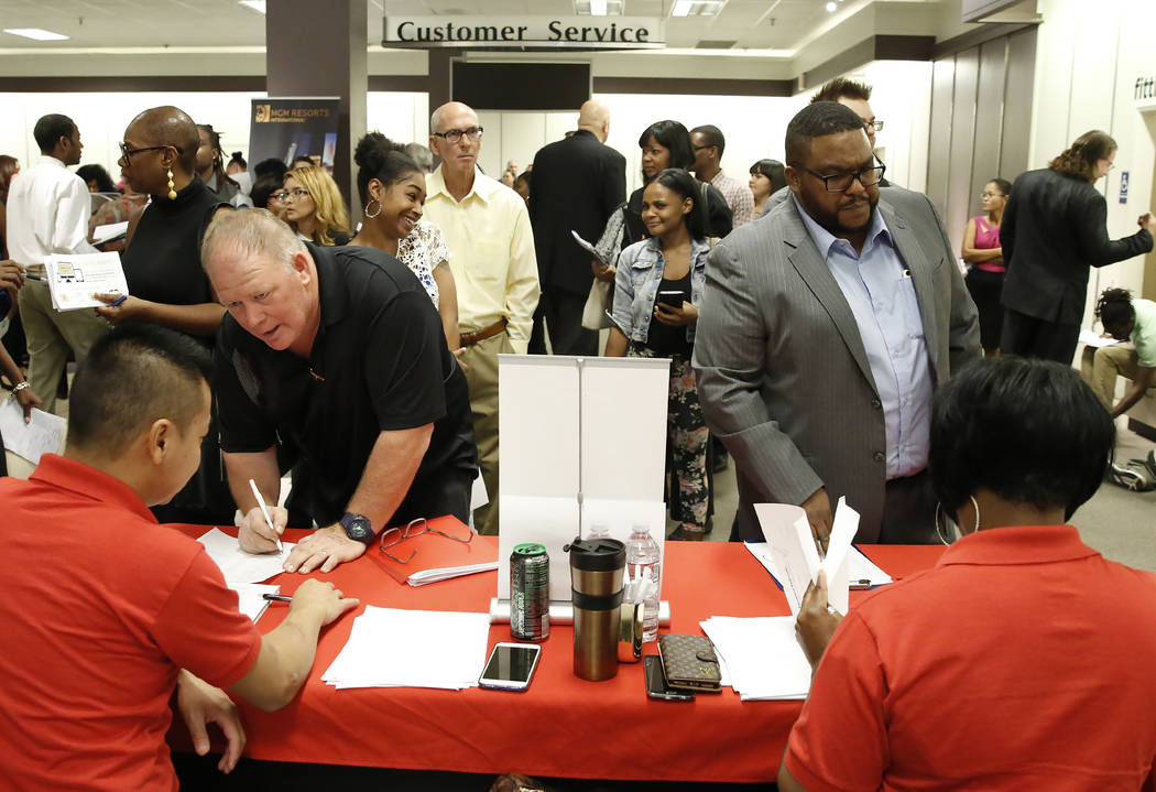 Job seekers, including Andre Peterson, right, speak to recruiters with Station Casino during the Nevada Day Super Hiring Event on Wednesday, Oct. 25, 2017 at the Boulevard Mall in Las Vegas. Bizua ...
