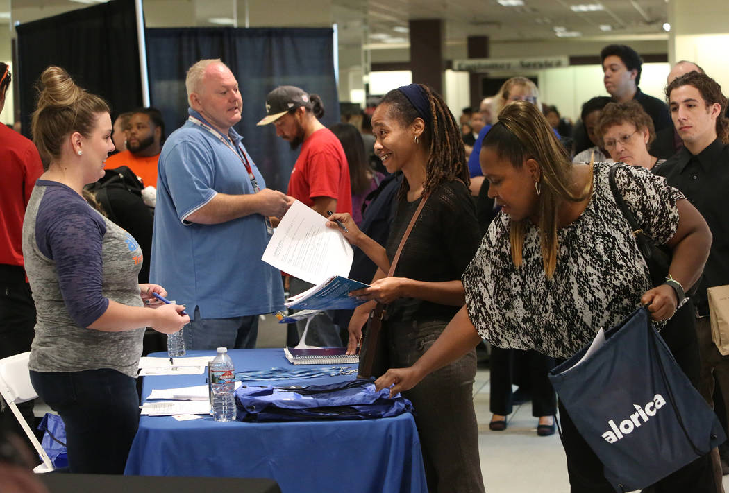 Megan Niblo, left, a recruiter with Allegiant Air, speaks to Latasha Jones, center, during the Nevada Day Super Hiring Event on Wednesday, Oct. 25, 2017 at the Boulevard Mall in Las Vegas. Bizuaye ...