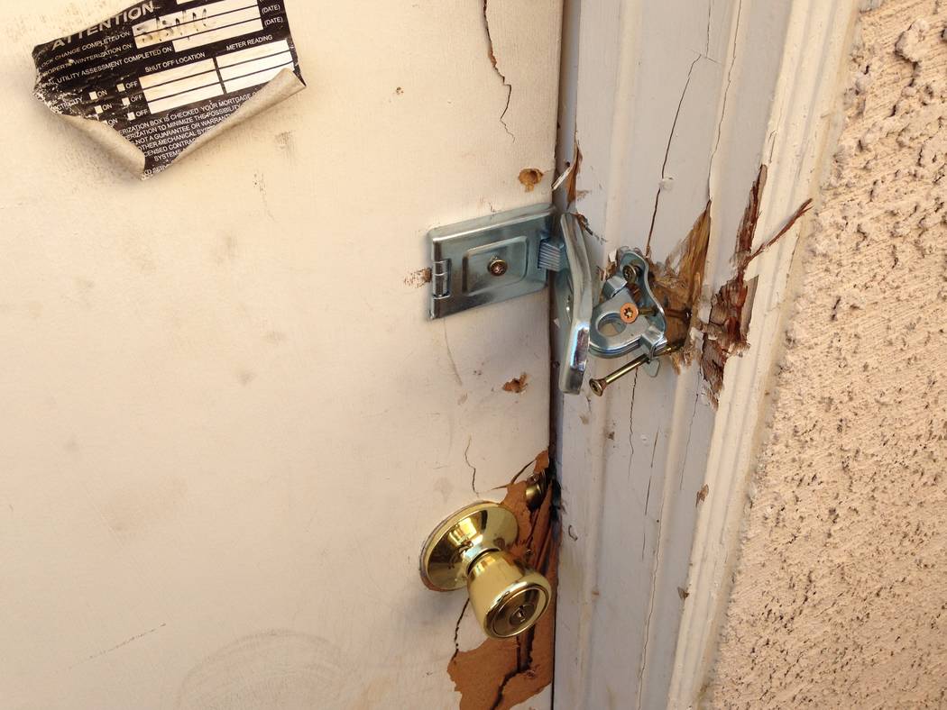 The side entrance to a squatter house near Buffalo Drive and Lake Mead Boulevard in Las Vegas, seen on Thursday, Oct. 12, 2017, was bolted shut by city code enforcement. (Eli Segall/Las Vegas Revi ...