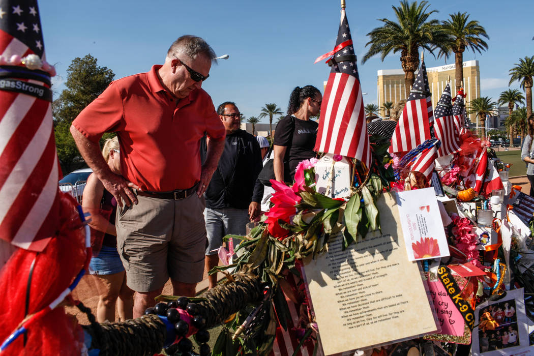 Steve Adams of Colorado and Henderson, 68, visits a memorial at the Welcome to Fabulous Las Vegas sign in Las Vegas, Monday, Oct. 16, 2017, honoring the victims of the Route 91 Harvest Festival ma ...