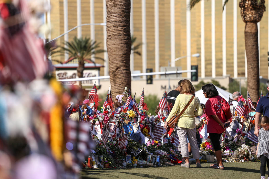 People visit a memorial at the Welcome to Fabulous Las Vegas sign in Las Vegas, Monday, Oct. 16, 2017, honoring the victims of the Route 91 Harvest Festival mass shooting. Joel Angel Juarez Las Ve ...