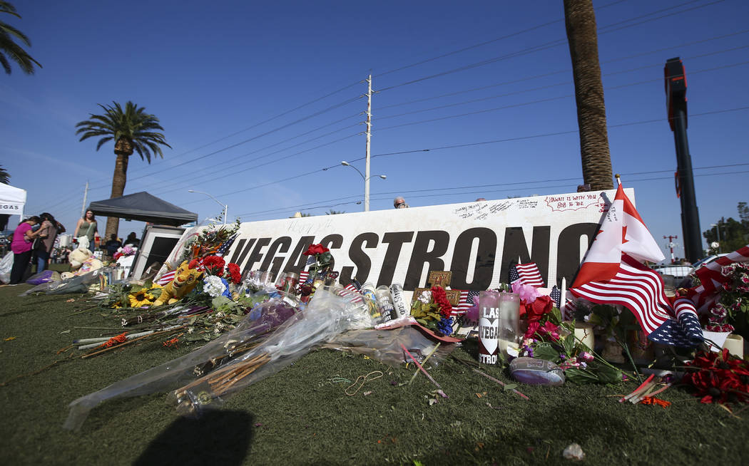 People visit a makeshift memorial near the &quot;Welcome to Fabulous Las Vegas&quot; sign in Las Vegas on Friday, Oct. 13, 2017. Chase Stevens Las Vegas Review-Journal @csstevensphoto