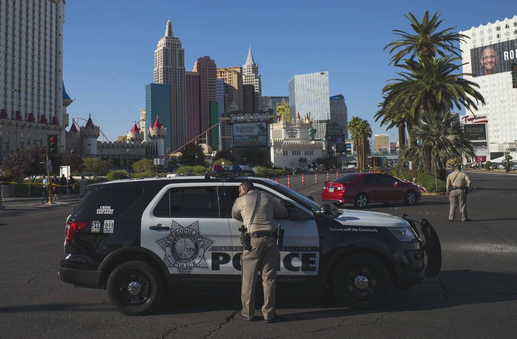 Las Vegas police officers talk at Las Vegas Boulevard and Reno Avenue outside of the Luxor, near the Route 91 Harvest festival grounds in Las Vegas on Tuesday, Oct. 3, 2017. A gunman opened fire o ...