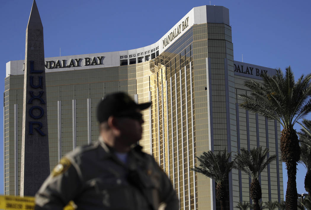 In this Oct. 3, 2017, file photo, a Las Vegas police officer stands by a blocked off area near the Mandalay Bay casino in Las Vegas. John Locher/The Associated Press