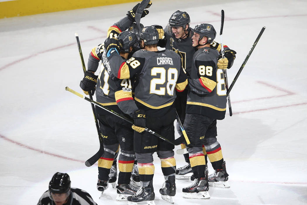 Golden Knights players celebrate a goal by Pierre-Edouard Bellemare (41) against the Chicago Blackhawks during an NHL hockey game at T-Mobile Arena in Las Vegas on Tuesday, Oct. 24, 2017. Chase St ...