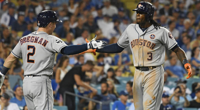 Oct 25, 2017; Los Angeles, CA, USA; Houston Astros center fielder Cameron Maybin (3) celebrates with third baseman Alex Bregman (2) after scoring in the eleventh inning against the Los Angeles Dod ...