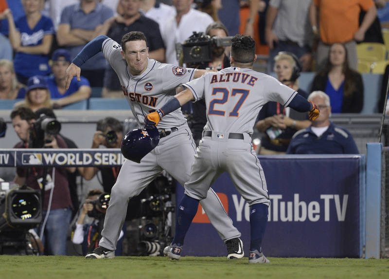 Oct 25, 2017; Los Angeles, CA, USA; Houston Astros second baseman Jose Altuve (27) celebrates with third baseman Alex Bregman (2) after hitting a solo home run against the Los Angeles Dodgers in t ...