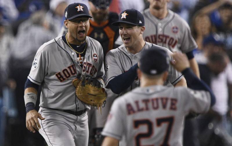Oct 25, 2017; Los Angeles, CA, USA; Houston Astros second baseman Jose Altuve (27) celebrates first baseman Yuli Gurriel (10) and third baseman Alex Bregman (2) after the Houston Astros defeated t ...