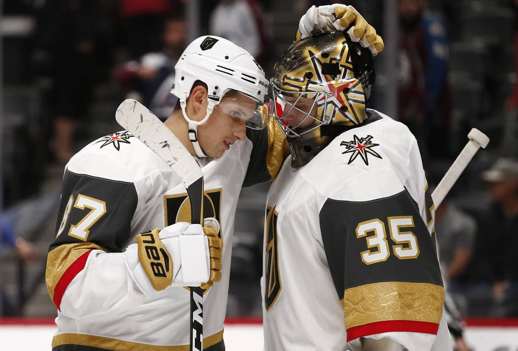 Las Vegas Golden Knights center Vadim Shipachyov (87) and goalie Oscar Dansk (35) celebrate a 4-1 victory over the Colorado Avalanche during a preseason hockey game, Tuesday, Sept. 19, 2017, in De ...