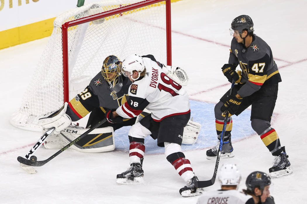 Vegas Golden Knights goalie Marc-Andre Fleury (29) deflects a shot from Arizona Coyotes center Christian Dvorak (18) during the third period of an NHL hockey game between the Vegas Golden Knights  ...