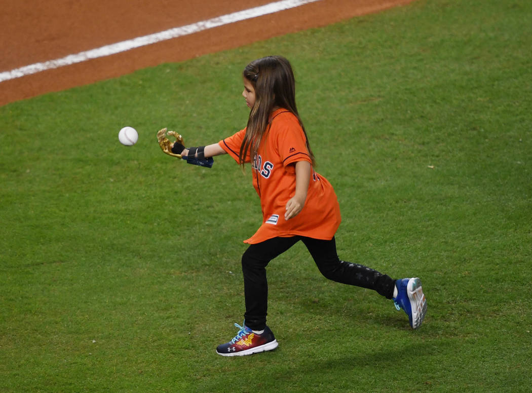 Oct 28, 2017; Houston, TX, USA; Hailey Dawson throws out the ceremonial first pitch before game four of the 2017 World Series between the Houston Astros and the Los Angeles Dodgers at Minute Maid  ...