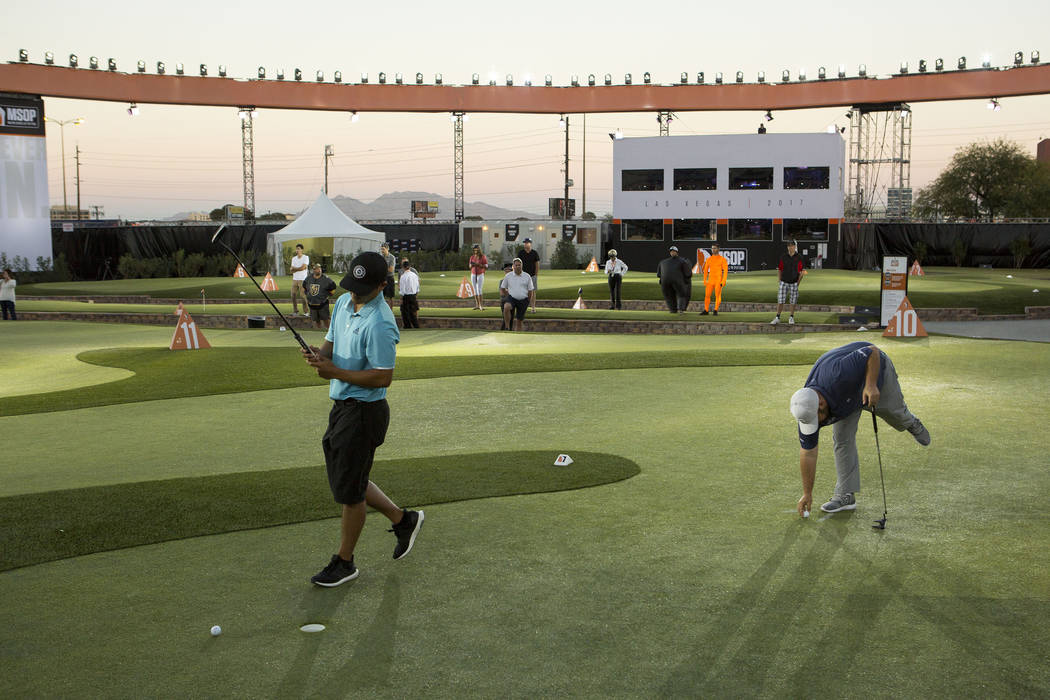 Colt Knost, right, prepares for a putt in the Major Series of Putting in Las Vegas on Tuesday, Oct. 31, 2017. Bridget Bennett Las Vegas Review-Journal @BridgetKBennett