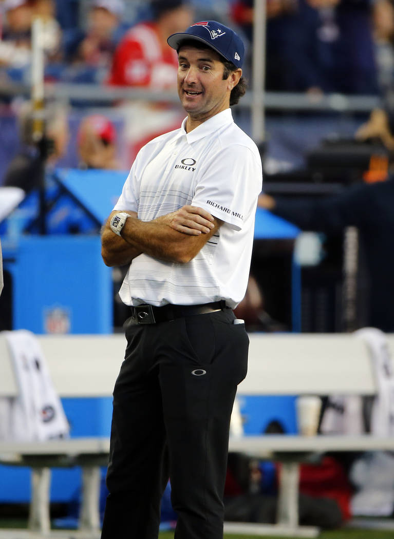 PGA tour golf player Bubba Watson wears a New England Patriots cap as he watches teams warm up before an NFL preseason football game between the Patriots and the New York Giants, Thursday, Aug. 31 ...