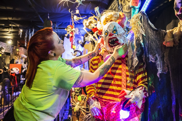 HalloweenMart employee Amber Rios adjusts a clown mask at the store, 6230 S. Decatur Blvd., Suite 101, Sept. 29, 2016, in Las Vegas. Benjamin Hager/View
