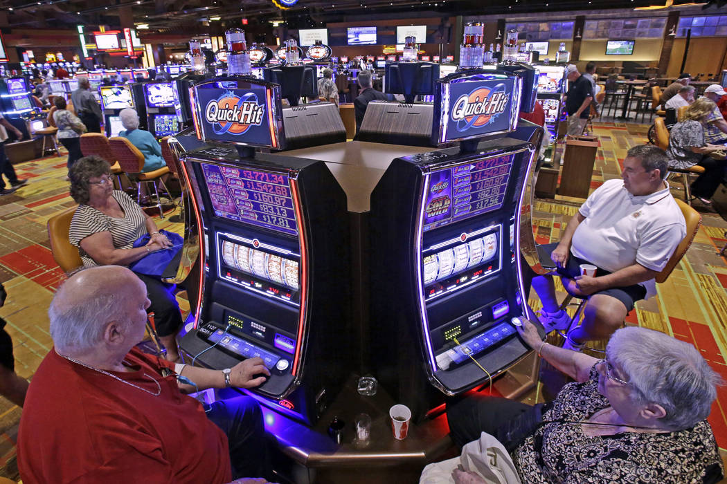 In this July 1, 2013 file photo, casino patrons play some of the 600 slot machines at the Lady Luck Casino Nemacolin, located approximately 70 miles south of Pittsburgh, shortly after its grand op ...