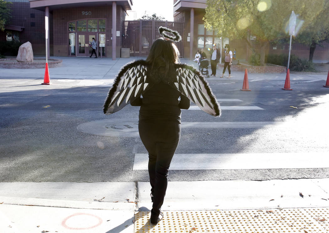 Viviana Zamorano dressed as a fallen angel crosses Tonopa Drive near Mabel Hoggard Elementary School on Tuesday, Oct. 31, 2017. Bizuayehu Tesfaye/Las Vegas Review-Journal @bizutesfaye