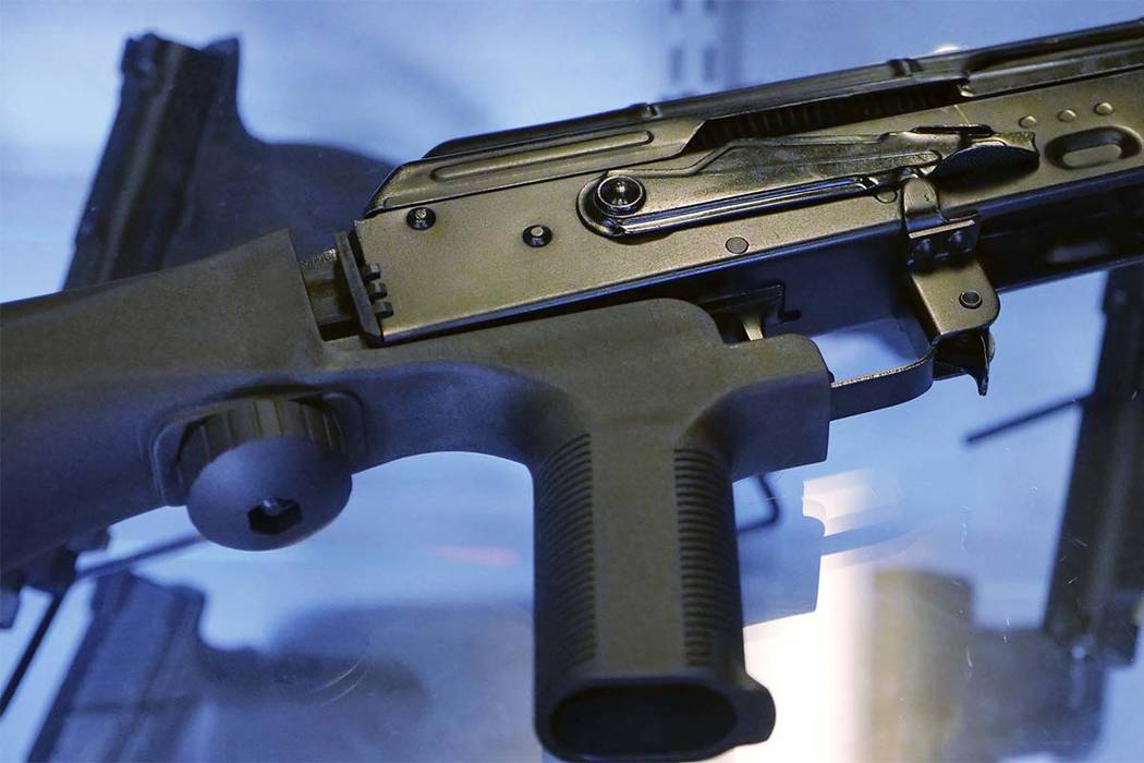 In this Oct. 4, 2017, photo, a device called a "bump stock" is attached to a semi-automatic rifle at the Gun Vault store and shooting range in South Jordan, Utah. The National Rifle Association an ...