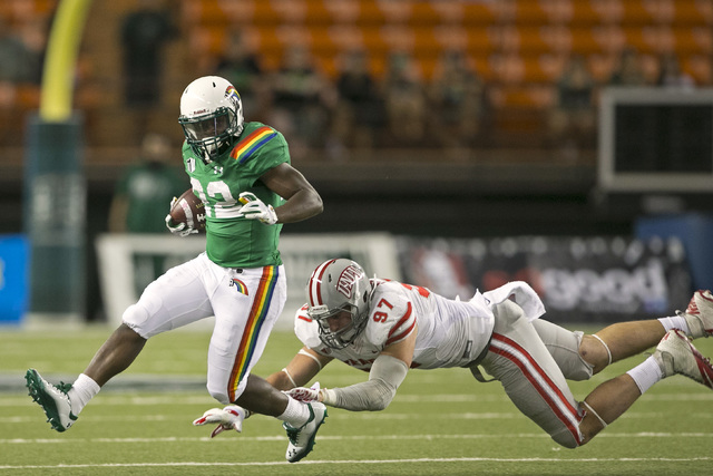 UNLV defensive lineman Dominic Baldwin (97) can't bring down Hawaii running back Diocemy Saint Juste (22) during the third quarter of the NCAA college football game at Aloha Stadium in Honolulu. ( ...