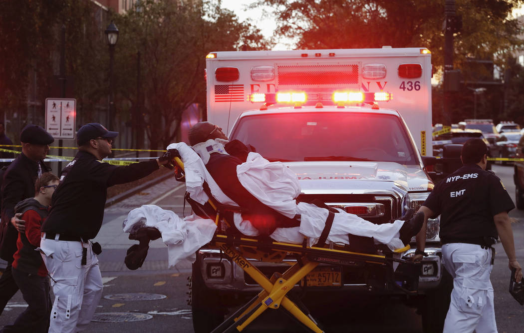 Emergency personnel transport a man on a stretcher after a motorist drove onto a busy bicycle path near the World Trade Center memorial and struck several people Tuesday, Oct. 31, 2017, in New Yor ...